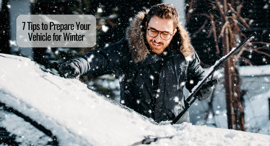 man cleaning snow off the windshield of his vehicle and his windshield wipers